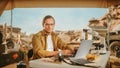 Archeological Digging Site: Portrait of Great Male Archaeologist Doing Research, Using Laptop, Looks