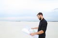 Archeologist man reviewing plan of excavations in village talk