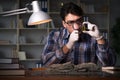 The archeologist working late night in office Royalty Free Stock Photo