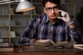 The archeologist working late night in office Royalty Free Stock Photo