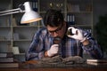 The archeologist working late night in office Royalty Free Stock Photo