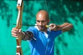 Archer aiming at target with bow and arrow Royalty Free Stock Photo