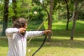 Ancient Precision: Skilled Archer Takes Aim at Medieval Archery Tournament in Forest Setting