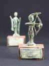 archer bronze statuette and chieftain praying with cloak and stick fgurine Royalty Free Stock Photo