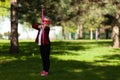 Archer child. Little girl takes aim with a bow in hands in the park outdoors. Superhero game Royalty Free Stock Photo