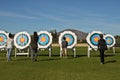 Archer collecting arrows from the targets in the field Royalty Free Stock Photo