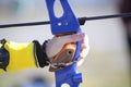 An archer hand pulling the string back of bow