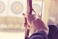 Archer holds his bow aiming at a target Royalty Free Stock Photo