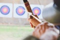 Archer holds his bow aiming at a target Royalty Free Stock Photo