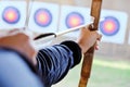 Archer holds his bow aiming at a target Royalty Free Stock Photo