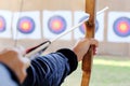 Archer holds his bow aiming at a target Royalty Free Stock Photo