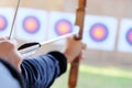 Archer holds his bow aiming at a target Royalty Free Stock Photo