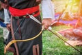 Archer in national dress with a bow and arrow in his hands. Hunter tribes on the warm summer day