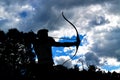 Archer of the side in silhouette with clouds