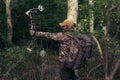 Archery hunter with his bow drawn back ready for a shot Royalty Free Stock Photo