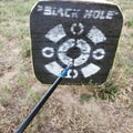 Archery practice with broadhead and target.