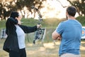 Archery, sports or help with a woman holding a bow and arrow outdoor for target practice with a coach. Coaching Royalty Free Stock Photo