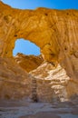 The Arches, amazing round hole in the rock, closed arch in ancient cooper mines canyons and mountains range in Timna National Park Royalty Free Stock Photo