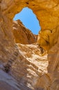 The Arches, amazing round hole in the rock, closed arch in ancient cooper mines canyons and mountains range in Timna National Park Royalty Free Stock Photo