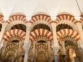 Arches of the ancient and impressive Mosque Cathedral of Cordoba from inside.