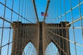 Arches on the Brooklyn Bridge with an American Flag in New York City and a Blue Sky Royalty Free Stock Photo