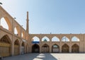 Arches of Imam Ali Square, historical Ali Minaret in Ali Mosque and green dome of Mausoleum of Harun-i Vilayat in Isfahan