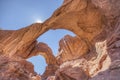 ARCHES NP, USA - JULY 2018: Tourists visit the beautiful and unique double arch located in Arches National Park, Utah USA