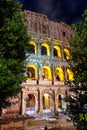 Arches of Rome Colosseum (Flavian Amphiteater) illuminated at night, Rome, Italy