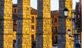 The arches of the Segovia aqueduct illuminated by the evening sunlight. Royalty Free Stock Photo