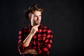 Archetypal image of Americans abroad. Cowboy life came to be highly romanticized. Man unshaven cowboy black background Royalty Free Stock Photo