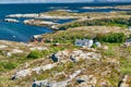 Archipelag view with white and red wooden hytte. Region Trondelag island Hitra, Froya, Fosen.