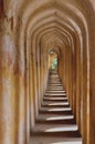 Architechtural Pattern of yellow old columns in a historical mosque building in india for tourists in a sunny day Royalty Free Stock Photo