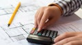 Architect analyzing building expenses with calculator in professional office environment Royalty Free Stock Photo