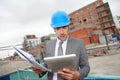 Architect with bluprint on building site Royalty Free Stock Photo