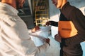 Architect and build engineer discuss project drawing