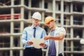 Architect and builder discussing at construction site Royalty Free Stock Photo