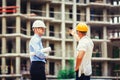 Architect and builder discussing at construction site Royalty Free Stock Photo