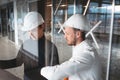 Architect and builder lookin on blueprint building under construction Royalty Free Stock Photo