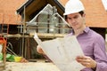 Architect On Building Site Looking At House Plans Royalty Free Stock Photo