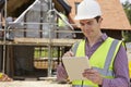 Architect On Building Site Using Digital Tablet