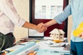 Architect and businessman handshake after finish an agreement in the office at  site construction Royalty Free Stock Photo