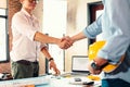 Architect and businessman handshake after finish an agreement in the office at  site construction Royalty Free Stock Photo