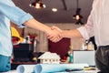 Architect and businessman handshake after finish an agreement in the office at  site construction Royalty Free Stock Photo