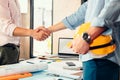 Architect and businessman handshake after finish an agreement in the office at  site construction Royalty Free Stock Photo