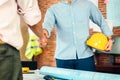 Architect and businessman handshake after finish an agreement in the office at  site construction Royalty Free Stock Photo