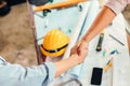Architect and businessman handshake after finish an agreement in the office at  site construction Royalty Free Stock Photo