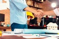 Architect and businessman handshake after finish an agreement in the office at  site construction Royalty Free Stock Photo