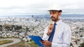 Architect or businessman in helmet with clipboard Royalty Free Stock Photo