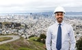 Architect or businessman in helmet over city Royalty Free Stock Photo