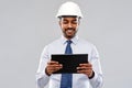 Architect or businessman in helmet with tablet pc Royalty Free Stock Photo